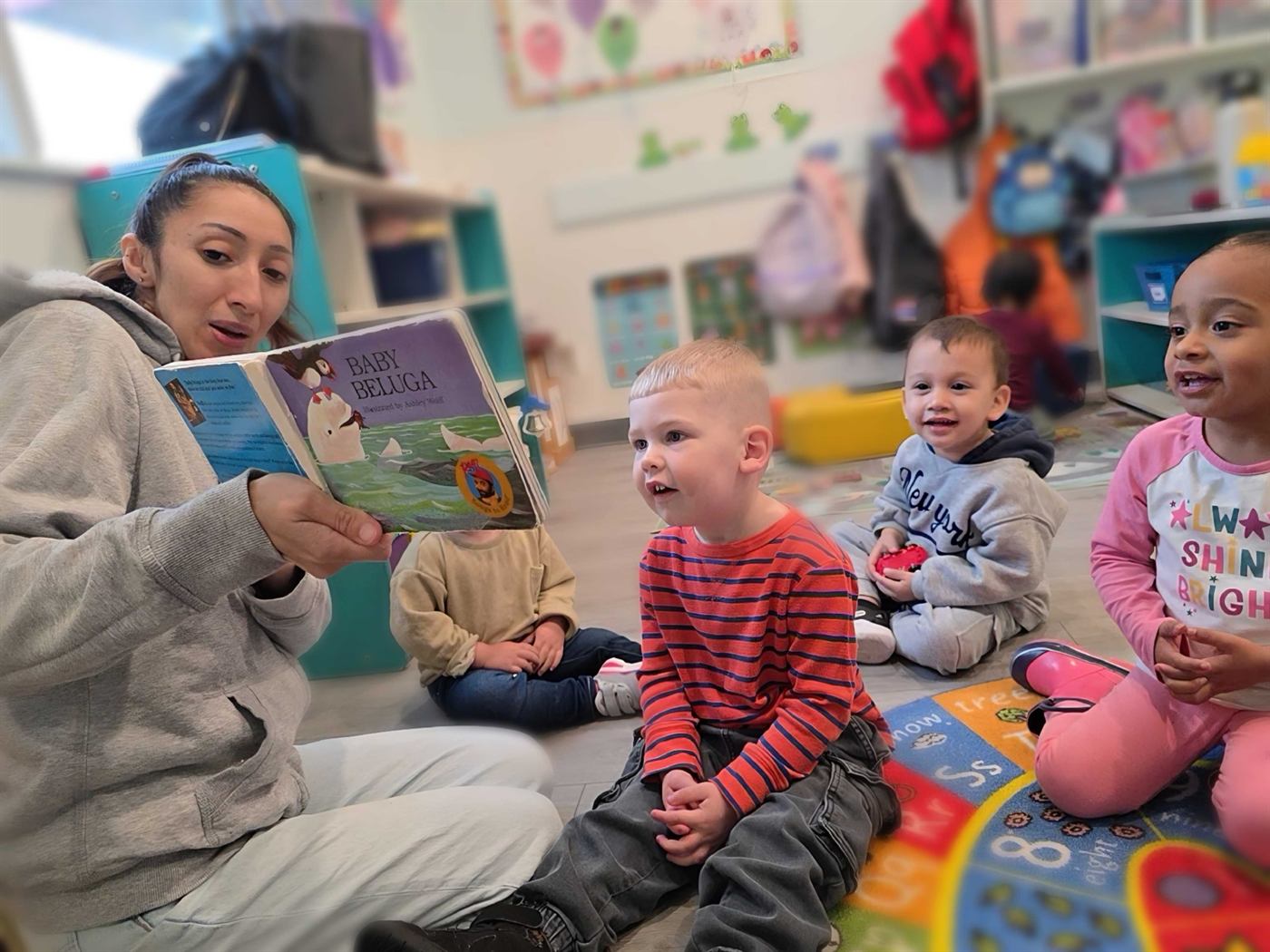 Teacher reading with young children at Zen Kids Care daycare